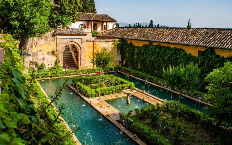 A courtyard with fountains and gardens