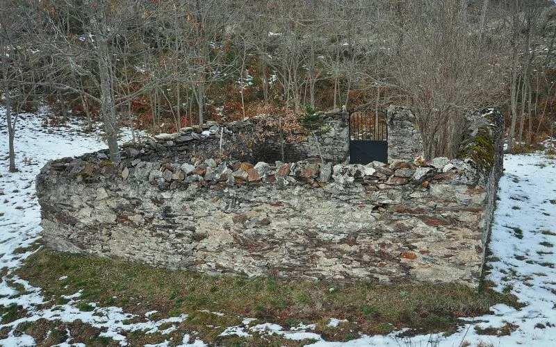 A small stone graveyard seen from the outside