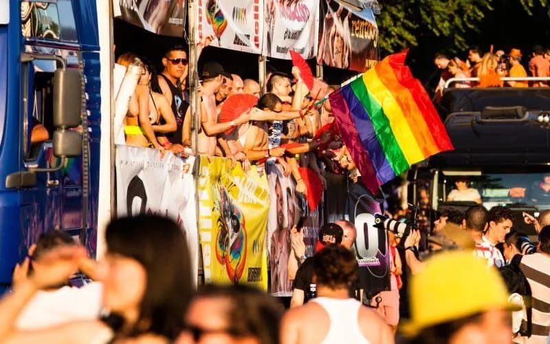 People celebrating pride in a truck