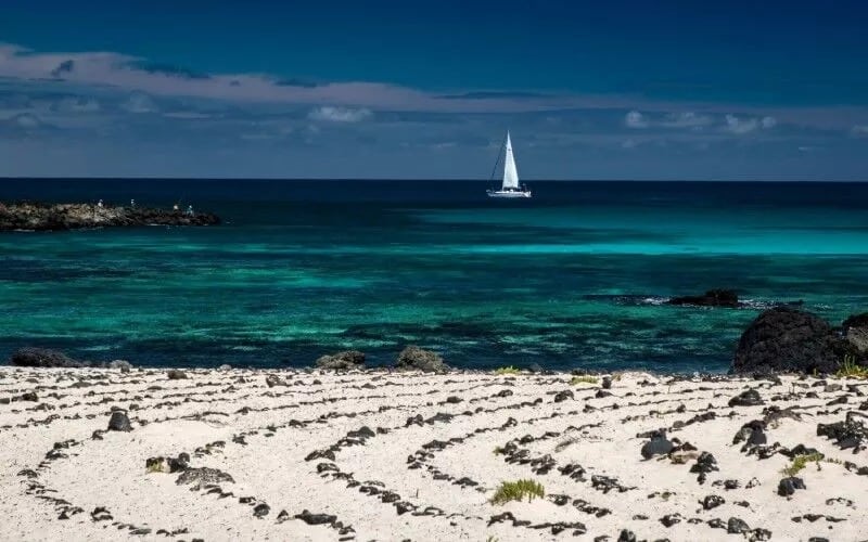 A beach with white sands and turquois water