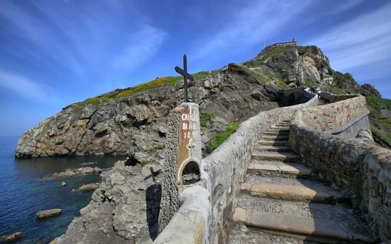 A view from the foot of the stairs, with a rocky slope and the sea in the background