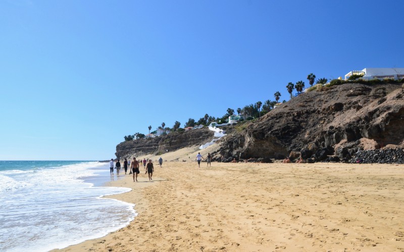 Some people walking on a beach