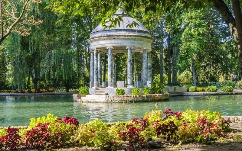 A temple on a pond surrounded by vegetation