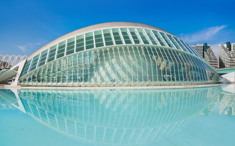 A modern building on a blue pond