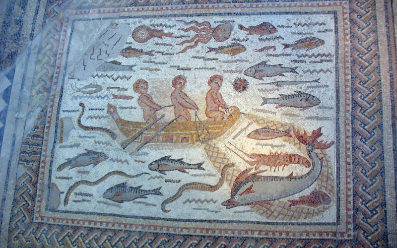 A mosaic depicting a fishing scene with children sailing on a boat and sea creatures