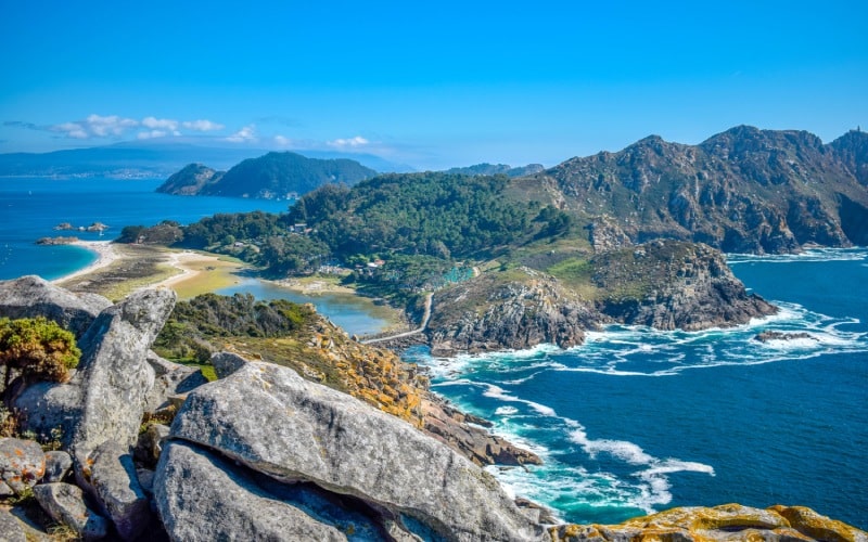 The panoramic view of a beautiful island with green cliffs, beaches and rocky slopes