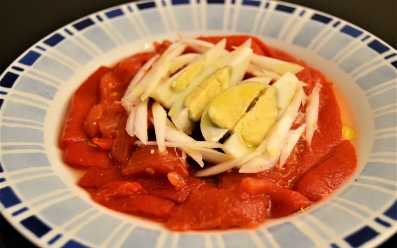 A salad with red peppers and eggs