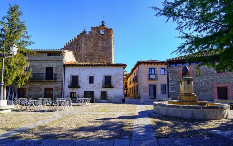 An old square with a stone fountain in the middle