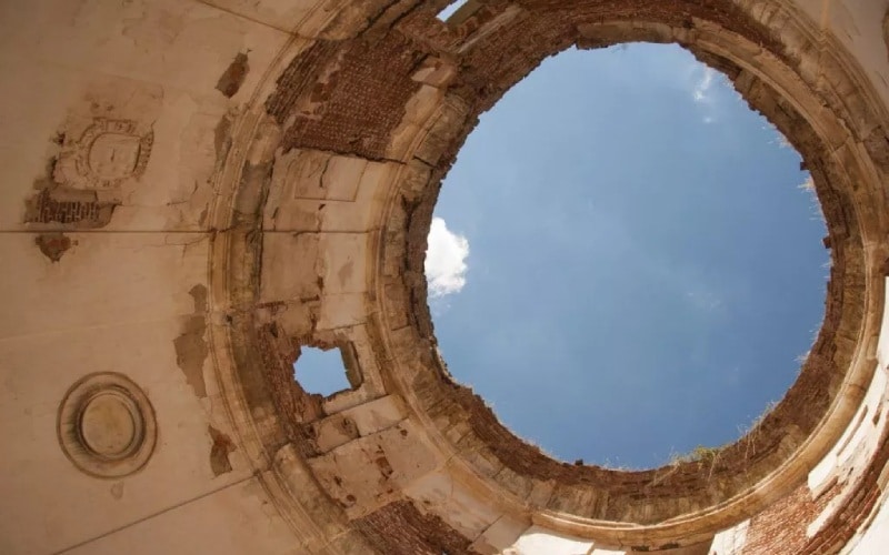 An old vault showing part of the blue sky from below