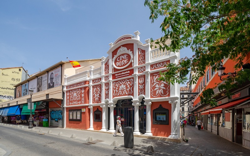 An old building with an orange and white movie theater