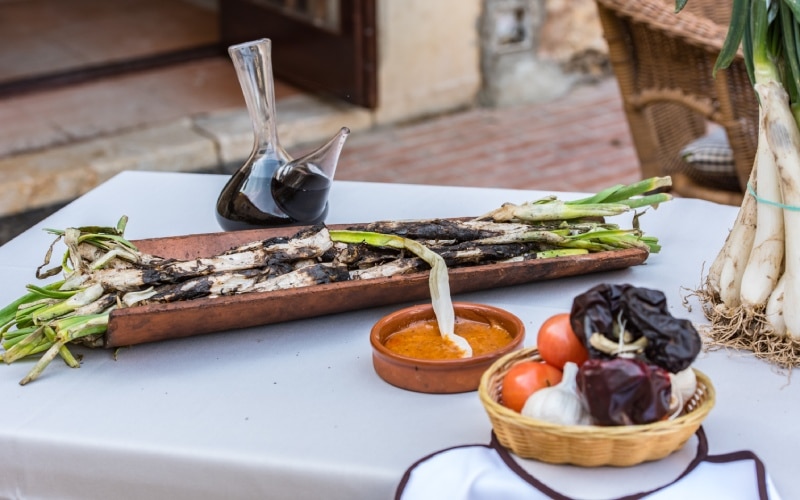 Some vegetables and a dish of salvitxada on a table