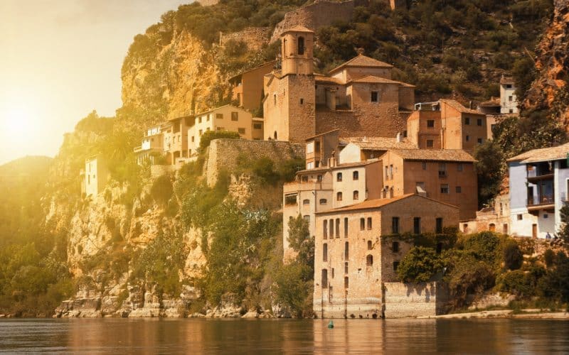 Stone houses gathered on a cliff over the river