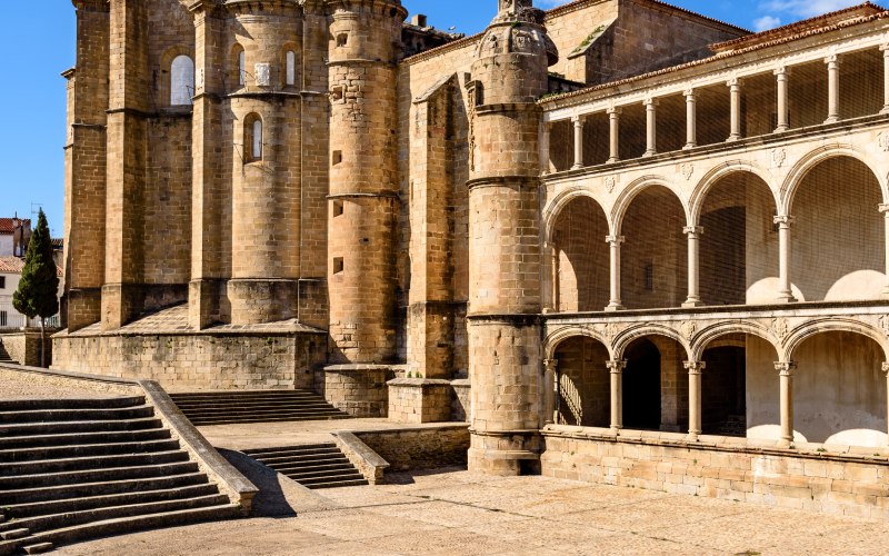 A historical building with archways and towers