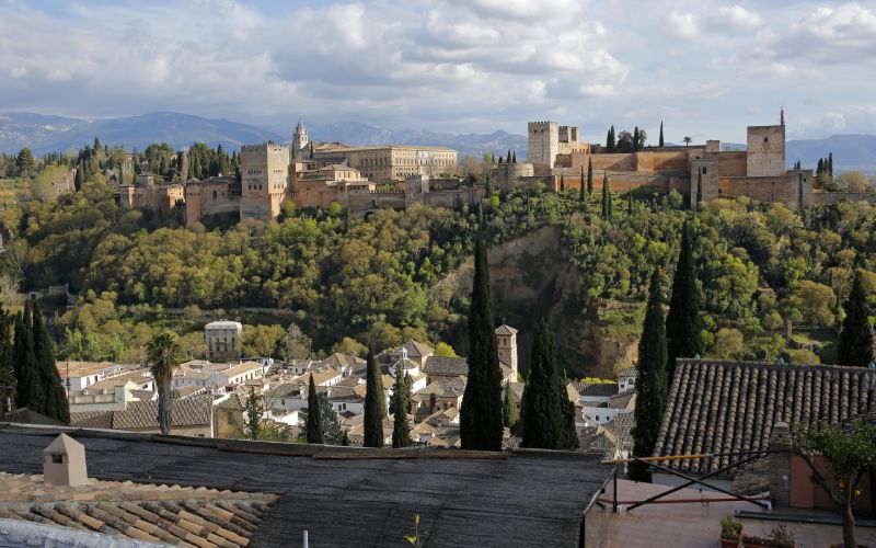 Trees and old buildings on a cliff