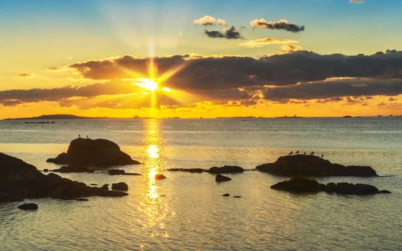 The sun setting over an island