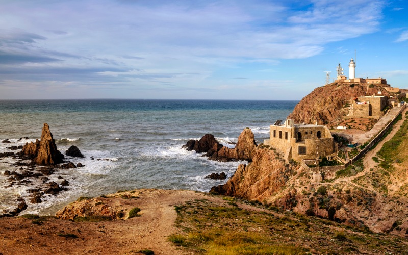Panoramic view of the coast with cliffs, rocks and some old buildings