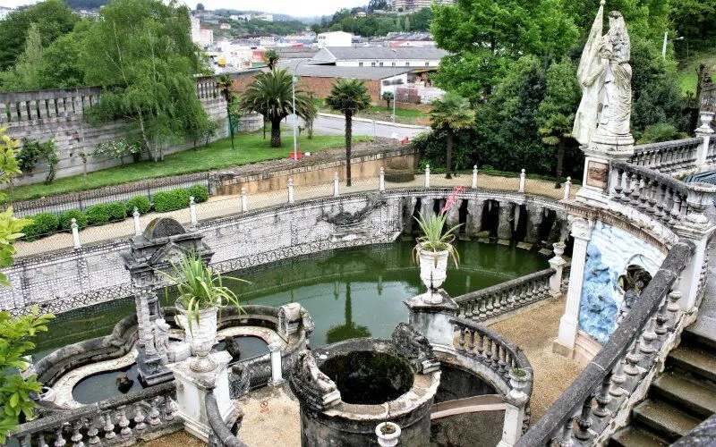 A park with sculptures and a pond