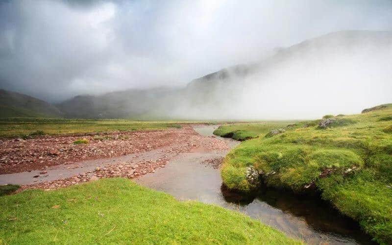 Mist spreading over a green valley