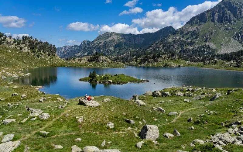 A valley with a lake surrounded by mountains