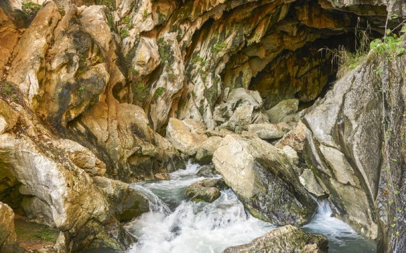 The interior of the cave of Cueva del Gato crossed by a stream